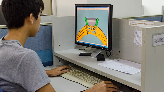 Worker using CAD/CAM to convert a hand drawing into a computer file