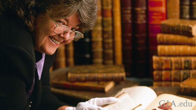 Geologist Dona Dirlam, here thumbing through volumes from GIA