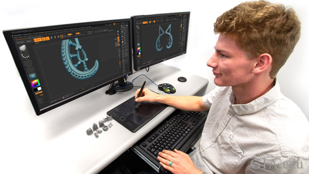 A student using Zbrush on a dual-monitor. 