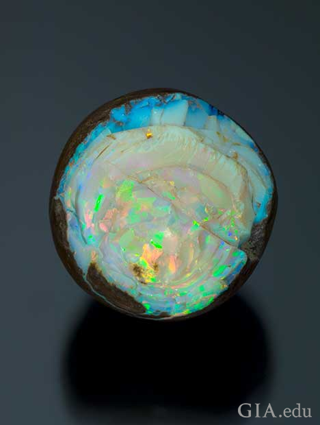 A front-facing piece of rough opal with the edges of its matrix showing. 
