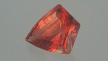 This striking 18.68-ct. shield-cut Oregon sunstone is truly a one-of-a-kind gem. It combines beautiful orange-red bodycolor with glittering copper inclusion accents. Gem courtesy of John Dyer & Co.