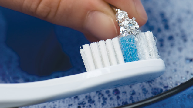 Scrubbing your jewellery with a soft, clean toothbrush helps remove leftover dirt. Just be careful not to use a toothbrush on jewellery that is too fragile, such as antique jewellery, to avoid any potential damage. Photo by Eric Welch/GIA