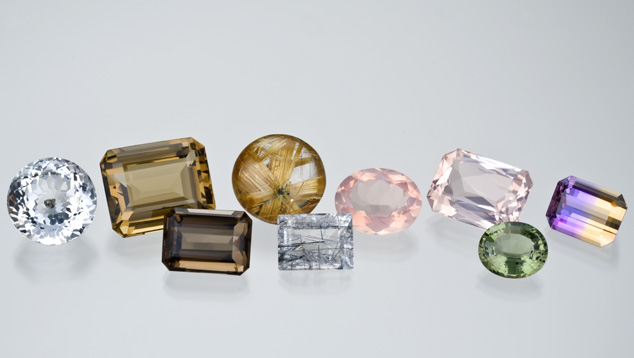 Rose quartz is the pastel pink quartz variety. This suite of quartz varieties includes colourless rock crystal quartz, smoky quartz, rutile quartz from Brazil, an oval rose quartz and a rose quartz octagon, as well as green praseolite and Bolivian ametrine quartz.