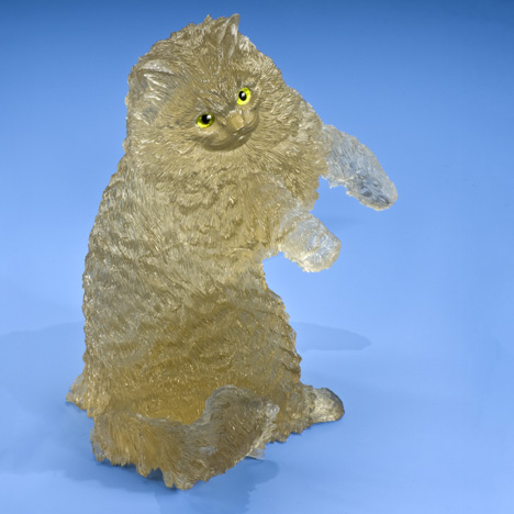 This golden cat is carved in citrine from Brazil. Its eyes are made of peridot and gold. - Robert Weldon