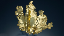 A large piece of gold in the shape of a leaf stands upright.