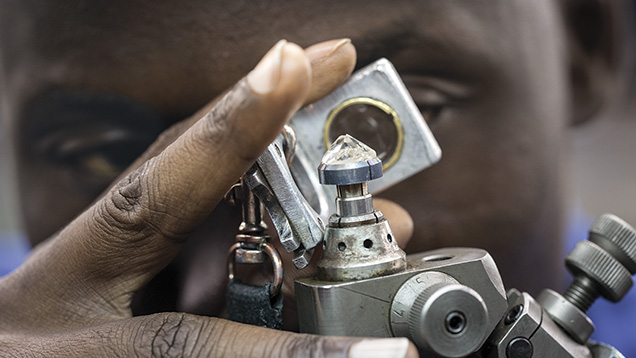 Laurelton employee examining a diamond