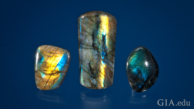 Three pieces of labradorite with yellow, blue and green flashes of color. 