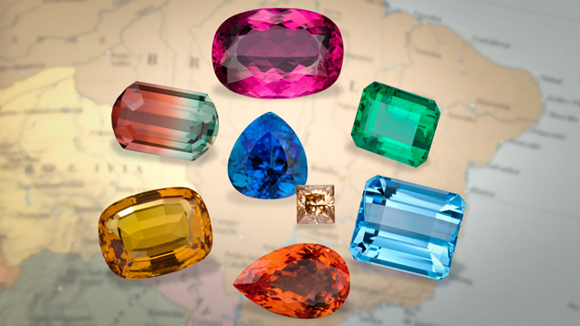 A selection of Brazilian gemstones. (From top, clockwise): rubellite tourmaline, emerald, aquamarine, imperial topaz, yellow topaz, bicolor tourmaline. Center: Paraiba tourmaline and brown diamond. Photo by Robert Weldon/GIA.