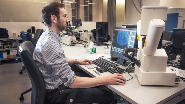 Evan Smith studies images of diamond inclusions on a computer.