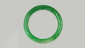 Jadeite jade and hydrogrossular garnet bangles.