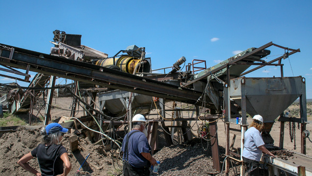 In this view of the mine’s processing plant, the shaker at top left is feeding ore into the yellow cylindrical trommel. Concentrate can either be directed to the hopper and belt in the foreground or to the optical sorting machine via the conveyor running diagonally to the left. - Duncan Pay