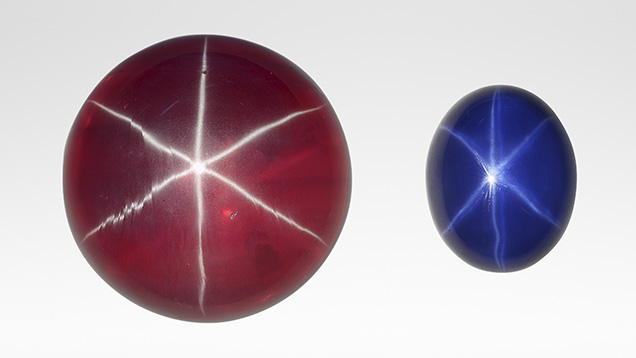 A large synthetic star ruby, left, and smaller synthetic star sapphire.