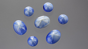 Glass cabochons exhibit fixed stars across their domes.