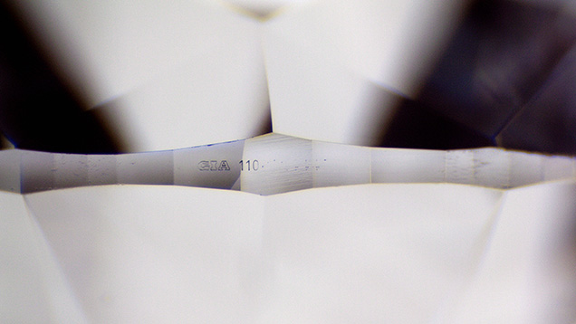 Remnants of an inscription seen on the girdle of the diamond.