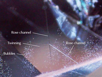 Bubbles, Rose channels, and twinning planes seen in synthetic sapphire.