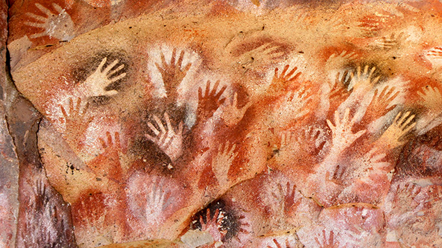 Hands stenciled using red ochre at the entrance of Cueva de las Manos.