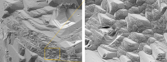 Figure 10. SEM image (left) of the edge between two prism faces, forming triangular hillocks, magnified on the right.