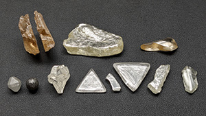 Figure 1. Examples of rough diamonds with shapes governed by various combinations of growth, breakage, and resorption. Specimens range from 1.08 to 28.08 ct, with the largest specimen measuring 27 mm in length. Photo by Evan M. Smith