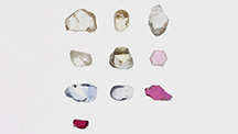 Figure 1. Color-calibrated photo of studied natural corundum crystals from various deposits ranging from 0.44 to 1.28 ct before heating. Photo by Sasithorn Engniwat.