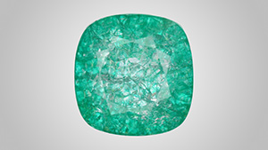 Figure 1. Face-up appearance of a quench-crackled and dyed laboratory-grown colorless sapphire, measuring 13.10 × 12.73 × 7.51 mm. Photo by Adriana Gudino.