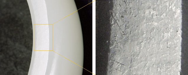 Figure 2. A section of a high-quality Russian white nephrite bracelet shows the distinctive orange peel effect, with lenticular contour ranging in size from 300 to 500 μm viewed under oblique illumination. Photo by Guanghai Shi.