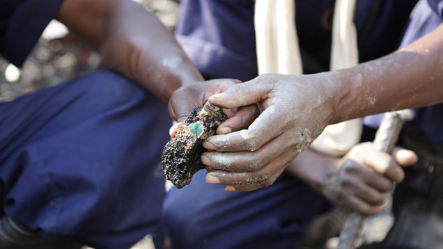 A worker at Gemfields’ Kagem mine in northern Zambia shows off a high-quality emerald embedded in matrix. The mine is the largest in Zambia and produces an estimated 20% of the world