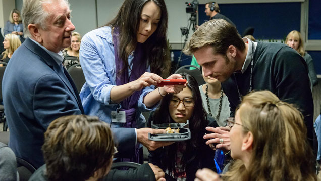 Students at GIA’s campus in Carlsbad gather around Larry French, store director of Buccellati Beverly Hills, as he shows them the “Gran Dama,” a brooch designed by Gianmaria Buccellati.  