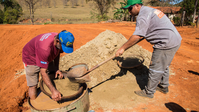 Miners often use water and specific gravity in a sifting exercise to separate out denser materials like gemstones. When the basket is emptied, upturned on the ground, the gems are visible on the top. Photo by Robert Weldon/GIA