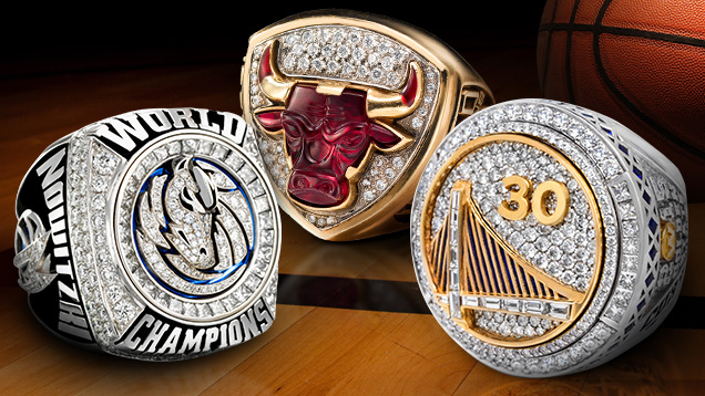 Image featuring the top faces of 2011 Dallas Mavericks, 1996 Chicago Bulls and 2015 Golden State Warriors NBA championship rings