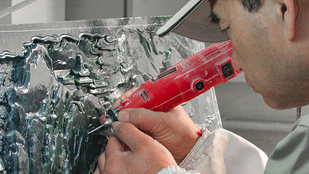 Chinese craftsman carving an intricate nephrite panel