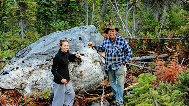 Makepeace and daughter near a large nephrite boulder  