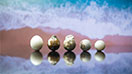 A row of five low-quality bead cultured pearls.