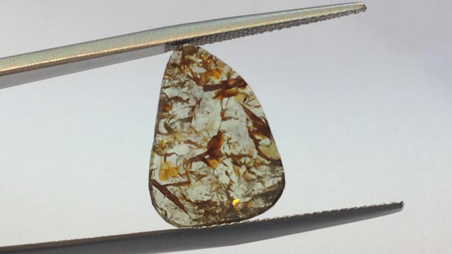 这种无色钻石切片的尺寸为 21×17×3 毫米左右，显示出富有吸引力的内含物图案。 这颗钻石在九月举办的香港钟表珠宝展上发售。 由 Dynamic International 友情提供。 摄影：Russell Shor。