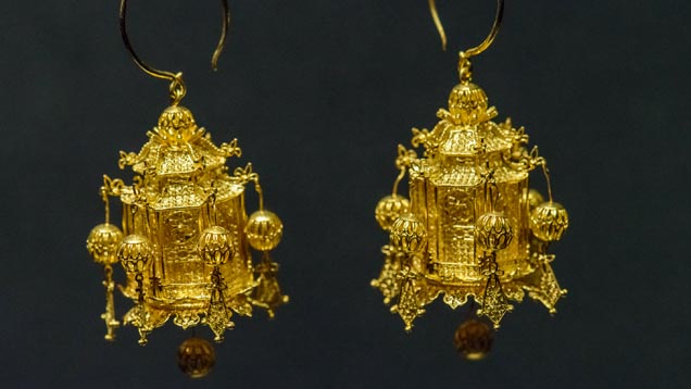 This pair of earrings is a replica of a Ming dynasty masterpiece. The earrings are 3-D replicas of lamps used in the Forbidden City. The lamps imitate pavilions with hexagonal profiles. Goldsmiths added seven spherical pendants to the pavilions. When the wearer moves, the pendants swing back and forth. Photo by Eric Welch/GIA.