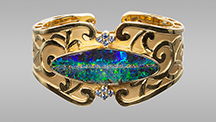 Boulder opal and sapphires in cuff bracelet.