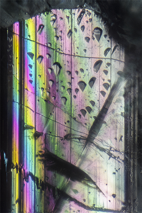Striations, triangular etch markings, and iridescence.