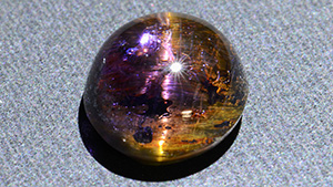 This cabochon displays an unusual yellowish chatoyancy.