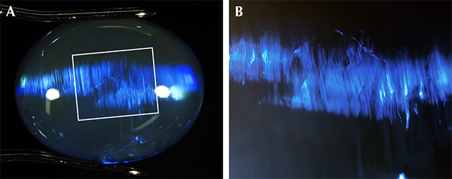 Parallel brushstroke patterns within the play-of-color patches in opal.