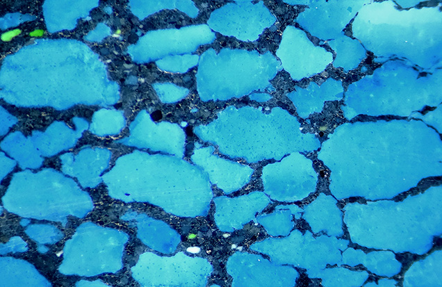 Cross section of one bead showed barite, minor calcite, and a black filling.