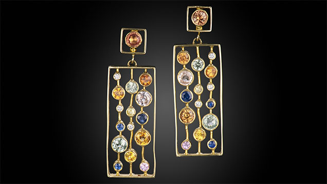Figure 3. “Event Horizon” earrings in 18K gold, diamond (0.07 carats total), and orange, mandarin, pink, green, and blue sapphire (5.2 carats total). Photo by Robert Weldon; courtesy of Sean Hill Designs.