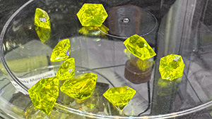 Figure 1. Yellow to greenish yellow faceted cerium-doped YAG “lumogarnets” ranging from 4 to 12 ct apiece. Photo by Lisa Kennedy; courtesy of Turtle’s Hoard.