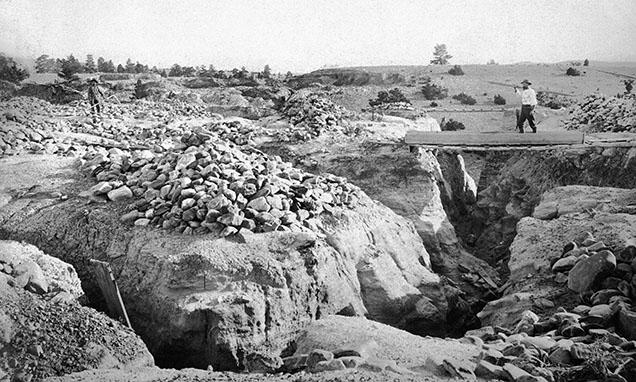 Figure 7. Mining operation at Dana’s Bar. The piles of rock are from the trenches below. Photo by Edgar H. Train between 1870 and 1879, Lot 026 B3F15.03 Dana’s Bar, Montana Historical Society Photograph Archives.