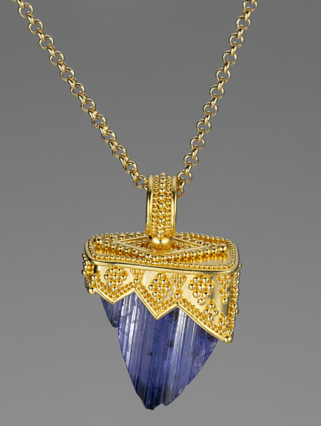Figure 3. Tanzanite pendant designed and fabricated by Elizabeth Gualtieri containing a 46.15 ct tanzanite crystal in a hand-fabricated setting of granulated 22K gold. Photo by Robert Weldon; courtesy of Zaffiro Jewelry.