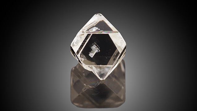 Figure 1. With a weight of 0.71 ct and measuring 5.88 mm in longest dimension, this glassy colorless diamond octahedron contains an eye-visible diamond inclusion. Photo by Diego Sanchez.