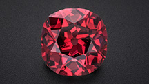 Figure 1. The 2.33 ct Winston Red diamond, displaying a vibrant Fancy red color. The old mine brilliant-cut stone measures approximately 8 mm in diameter. Photo by Robert Weldon; courtesy of Ronald Winston.