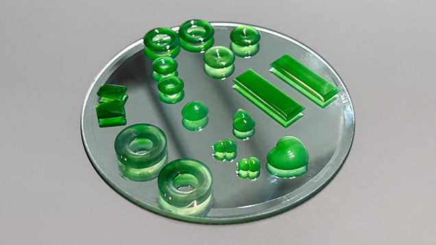 Figure 2. Several Guatemalan jade pieces placed on a mirror to demonstrate the transparency of the material. Photo by Jennifer Stone-Sundberg; courtesy of Pillar & Stone.