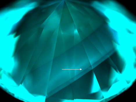 Figure 3. DiamondView imaging of the pavilion of the 1.09 ct diamond. The fluorescence color was consistent with HPHT-treated CVD-grown diamond. The region corresponding to the blue band is indicated by an arrow.