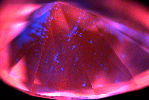 Figure 2. Representative deep-UV fluorescence image of a 2.90 ct CVD diamond from Plasmability, collected using the DiamondView. The image is dominated by red–orange fluorescence from NV<sup>0</sup> centers, a common feature for untreated CVD laboratory-grown diamonds, along with irregular blue fluorescing dislocation bundles. No growth layers were observed, indicating that it was produced through a single uninterrupted growth cycle. Image by Madelyn Dragone.