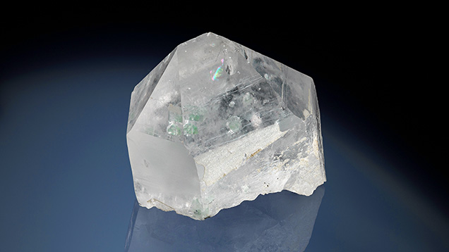 Figure 1. Transparent, colorless terminated 3230.50 ct single crystal of Chinese quartz with geometric growth features decorating the surface with eye-visible apple green inclusions. Photo by Annie Haynes.