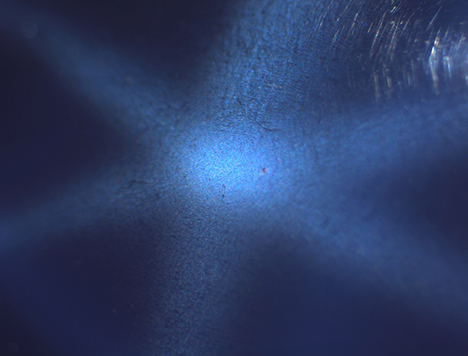 Needle-like inclusions causing asterism in synthetic sapphire.